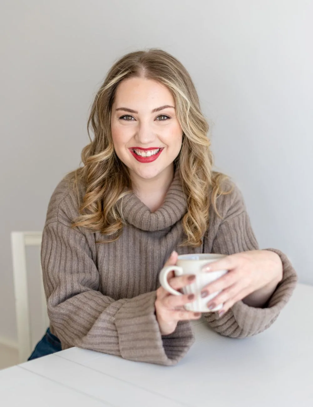 Megan Elliott, copywriter and founder of The Copy Template Shop, smiling and holding a mug