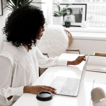 woman learning to write your own website on her laptop