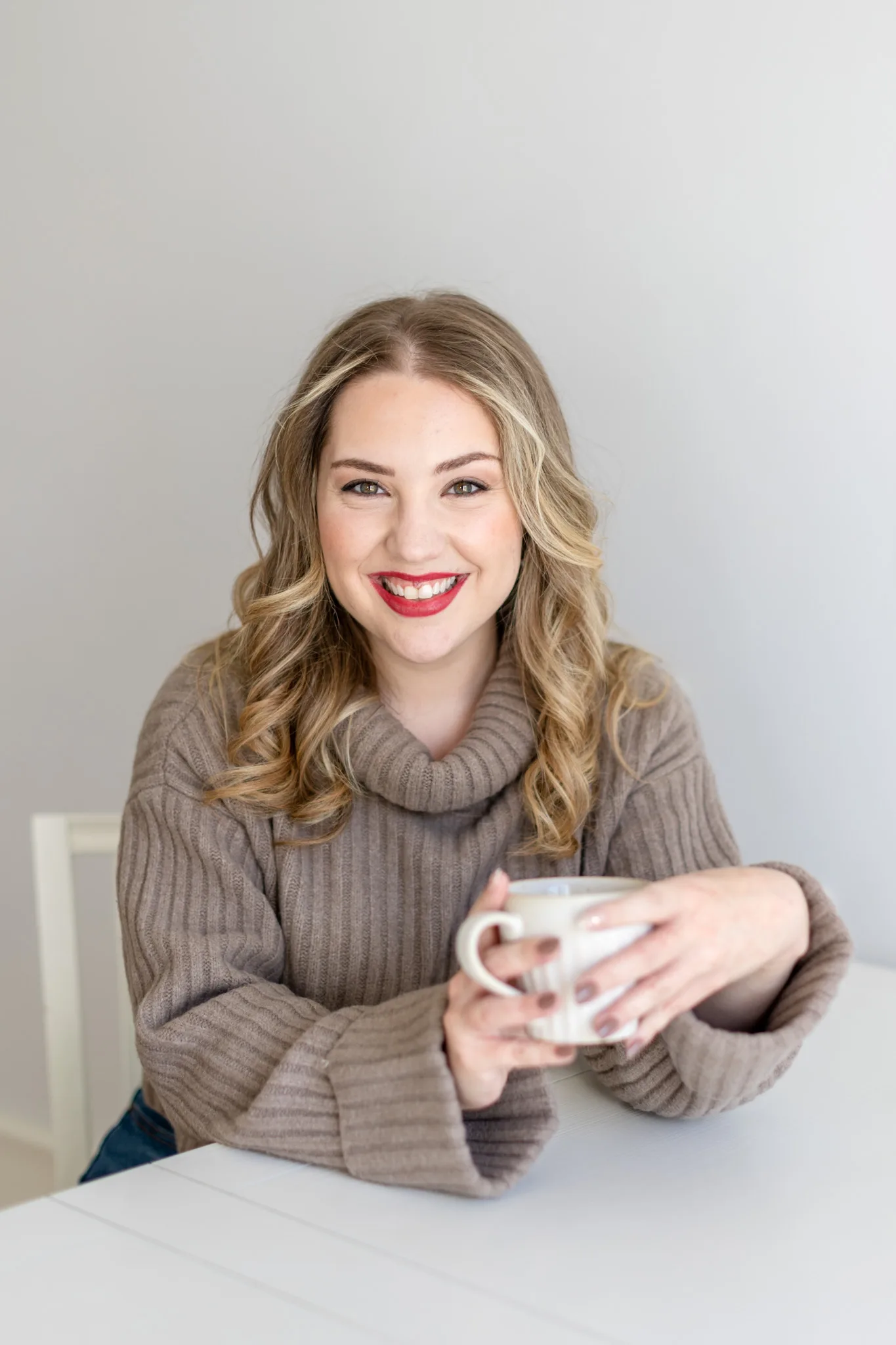 Megan Elliott, copywriter and creator of Strongly Brewed Websites website copywriting course, holding a mug and smiling