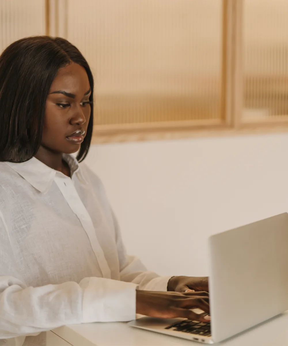 Person writing website copy on a laptop — Strongly Brewed Websites module 6