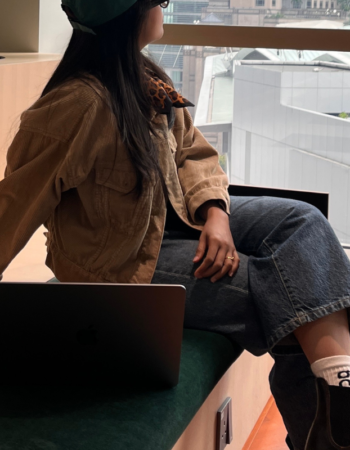 Online service provider sitting with laptop in a modern coworking space