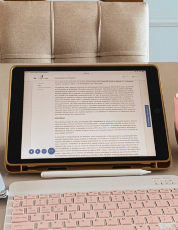 Gold laptop and pen on a white desk — what to include on a services page to book more clients